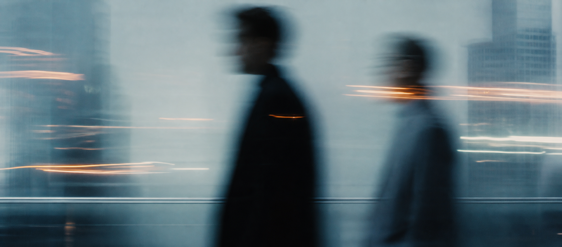 Business professionals moving through a modern city in long exposure